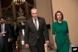 FILE - Senate Democratic Minority Leader Chuck Schumer and House Democratic Leader Nancy Pelosi, the speaker-designate for the new Congress, arrive to talk to reporters at the Capitol in Washington, Dec. 20, 2018.