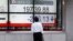 A man looks at an electronic board showing Japan's Nikkei average outside a brokerage at a business district in Tokyo, Aug. 9, 2017. 