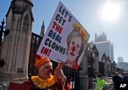 A Demonstrator protests at the entrance of the Houses of Parliament in London, Feb. 26, 2019.