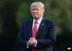President Donald Trump walks from Marine One across the South Lawn of the White House in Washington, Wednesday, Aug. 23, 2017, as he returns from Reno, Nevada.
