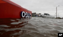 The roof of a gas station sits in flood waters in the wake of Hurricane Harvey, Aug. 26, 2017, in Aransas Pass, Texas.