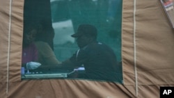 FILE - A man has his blood taken before being tested for HIV in Harare, Zimbabwe, May 9, 2014. Four southern African countries are in the process of introducing self-testing.