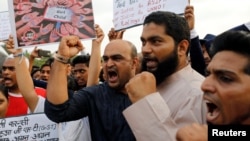 People shout slogans as they participate in a protest against the rape of an eight-year-old girl in Kathua near Jammu, and a teenager in Unnao, Uttar Pradesh state, in Mumbai, Apr. 15, 2018. 