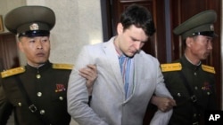 FILE - American student Otto Warmbier, center, is escorted at the Supreme Court in Pyongyang, North Korea, March 16, 2016.
