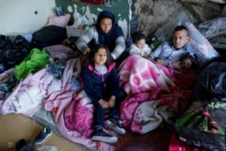 FILE - Migrants are seen near a bus station in Edirne, Turkey, March 6, 2020.