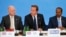 Britain's Prime Minister David Cameron (C) sits with Foreign Secretary William Hague (L) and Somali President Hassan Sheikh Mohamud, as he speaks at the Somalia conference in London, May 7, 2013. 