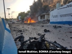Debris litters a Mogadishu street after a car bomb exploded next to a restaurant in the Somali capital, May 24, 2017, killing eight people and injuring 15.