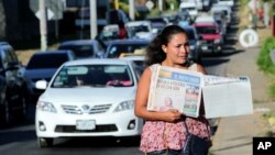 A street vendor sells La Prensa, a local newspaper showing a blank front page as a sign of protest against Daniel Ortega's government, in Managua, Nicaragua Jan. 18, 2019. 