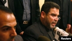 FILE - Hamas official Salah al-Bardawil, right, talks during a news conference in Cairo, Jan. 14, 2009. Al-Bardawil on Thursday accused Israeli intelligence of being behind an IS video in order “distort the resistance.”