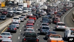 FILE - Southbound traffic on Interstate 5 moves through Los Angeles. President Donald Trump announced a review last week of tough Obama-era vehicle emissions and fuel-efficiency standards.