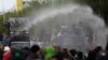Police use water cannons to disperse anti-government protesters in Bangkok, Thailand, July 18, 2021. Hundreds of demonstrators rallied on Sunday despite the government’s recent coronavirus measures to prohibit the gathering of more than five people. 