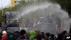 Police use water cannons to disperse anti-government protesters in Bangkok, Thailand, July 18, 2021. Hundreds of demonstrators rallied on Sunday despite the government’s recent coronavirus measures to prohibit the gathering of more than five people. 