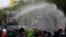 Police use water cannons to disperse anti-government protesters in Bangkok, Thailand, July 18, 2021. Hundreds of demonstrators rallied on Sunday despite the government’s recent coronavirus measures to prohibit the gathering of more than five people. 