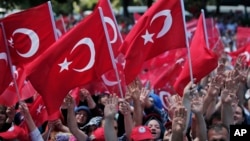 Pro-government demonstrators wave Turkish flags as they protest against the attempted coup, in Istanbul, Turkey, July 19, 2016. The Turkish government accelerated its crackdown on alleged plotters of the failed coup against President Recep Tayyip Erdogan.