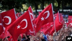 FILE - Pro-government demonstrators wave Turkish flags as they rally against the attempted coup in Istanbul, Turkey, July 19, 2016. The Turkish government accelerated its crackdown on alleged plotters of the failed coup against President Recep Tayyip Erdogan.
