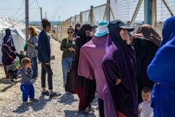 A group of women, reportedly the wives of suspected Islamic State fighters, are pictured on March 28, 2021 at Camp al-Roj.