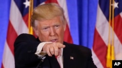 Police officers carry the coffins of the four victims of last week's knife attack during a ceremony in the courtyard of the Paris police headquarters. France's presidency said the victims will be posthumously given the country's highest award, the Legion of Honor.