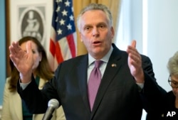 FILE - Virginia Gov. Terry McAuliffe, gestures during a news conference at the Capitol in Richmond, Va., Jan. 10, 2017.