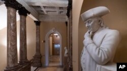 A statue of Benjamin Franklin is seen in an empty corridor outside the Senate at the Capitol in Washington, Dec. 27, 2018, during a partial government shutdown. 
