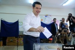 Greek Prime Minister Alexis Tsipras votes at a polling station in Athens, July 5, 2015.