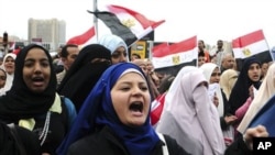 Egyptian anti-Mubarak protesters shout slogans as they march in Alexandria, Egypt, Saturday, Feb. 5, 2011