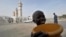 FILE - A young talibe raises a begging bowl in front of the grand mosque in Touba, in the central region of Senegal, Feb. 23, 2012. 