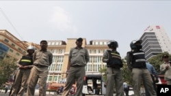 Cambodian police officers stand guard in front of the Phnom Penh Municipal Court during a hearing of Kem Sokha, the head of the dissolved Cambodia National Rescue Party, in Phnom Penh, Cambodia, Jan. 16, 2020.