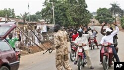 A soldier searches a car in Kaduna, Nigeria, April 21, 2011