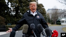 President Donald Trump talks with reporters outside the White House before traveling to Alabama to visit areas affected by the deadly tornadoes, March 8, 2019.