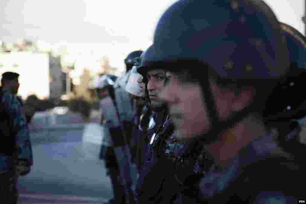 Riot police pushed back protesters angry about subsidy cuts. (Y. Weeks for VOA)