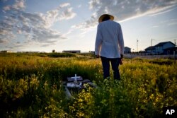 Kenny Still Smoking stands over the tombstone of his 7-year-old daughter, Monica, who disappeared from school in 1979 and was found frozen on a mountain, as he visits her grave on the Blackfeet Indian Reservation in Browning, Mont., July 14, 2018. "I talk to her, let her know I'm doing OK, that I'm still kicking," he said. "I think about her all the time."