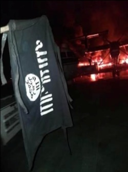 FILE - An image distributed by al-Shabab after the attack on a military base in Kenya shows Somalia's al-Shabab militant group's flag, said to be at the Manda Bay Airfield in Manda, Lamu, Kenya, Jan. 5, 2020.