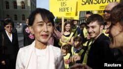 Burma's opposition leader Aung San Suu Kyi is welcomed by supporters outside the Swiss Parliament building in Bern June 15, 2012. 