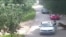 This video frame grab received from China's state broadcaster CCTV on July 25, 2016, shows a tiger (far R) attacking a passenger after she stepped out a car at Beijing Badaling Wildlife World on July 23, 2016.