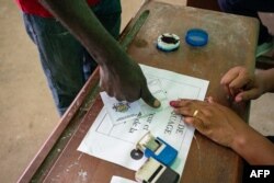 A voter registers to vote at a polling station during Gabon's referendum in Libreville, Nov. 16, 2024.