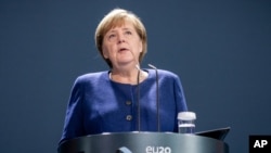 German Chancellor Angela Merkel addresses the media during a statement at the chancellery in Berlin, Germany, Nov. 9, 2020 on the results of the US elections.