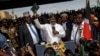 Opposition leader Raila Odinga holds up a bible during a "swearing-in" ceremony at Uhuru Park in downtown Nairobi, Kenya, Jan. 30, 2018.