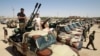 Members of the Libyan National Army gather in the city of Benghazi, on their way to reportedly back up fellow LNA fighters on the frontline west of Sirte, facing forces loyal to the UN-recognized Government of National Accord, on June 18, 2020. 