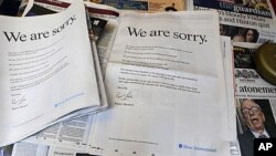 Newspapers at a news vendor in central London, with the advertisement apology for News International, July 16, 2011. News Corporation chairman Rupert Murdoch signed the company advert entitled "We are sorry", which appears in British national newspapers.