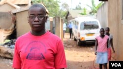 FILE - Phiona Mutesi stands near where she grew up in Katwe, Kampala, Uganda, Jan. 28, 2012. (H. Heuler/VOA)