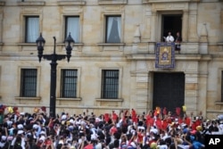 Pope Francis stands over the crowd from Cardinal's Palace where he is to give a blessing at Bolivar Square in Bogota, Colombia, Sept. 7, 2017.