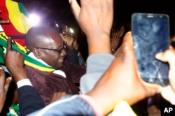 FILE - Pastor Evan Mawarire leaves the Harare Magistrates Court, Zimbabwe, July 13, 2016, after the court freed him ruling that police violated his rights.