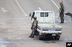 Armed soldiers patrol a street in Harare, Zimbabwe, Nov. 15, 2017.