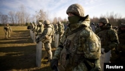 Ukrainian border guards line up at the frontier with Belarus in Ukraine's Volyn region, Nov. 11, 2021. (Ukraine Interior Ministry Press Service/Handout via Reuters)