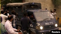 FILE - Pakistani police drive men accused of child abuse to the Lahore High Court in Pakistan, August 11, 2015.