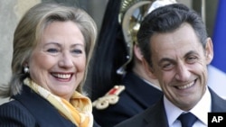 U.S. Secretary of State Hillary Clinton (L) is greeted by France's President Nicolas Sarkozy upon her arrival at the Elysee Palace in Paris, March 14, 2011