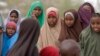 FILE - Children watch as another child is vaccinated in the town of Liboi, Kenya, July 27, 2011. Kenyan authorities on Friday launched a mass vaccination program against the human papilloma virus, or HPV.