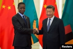 FILE - Zambia’s President Edgar Lungu shakes hands with China’s President Xi Jinping before their bilateral meeting at the Great Hall of the People in Beijing, China, Sept. 1, 2018.