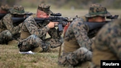 FILE - U.S. Marines take part in marksmanship qualification at Guantanamo Bay U.S. Naval Base, March 6, 2013.