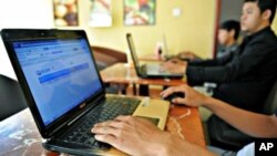 Cambodian men using the Internet at a coffee shop in Phnom Penh.